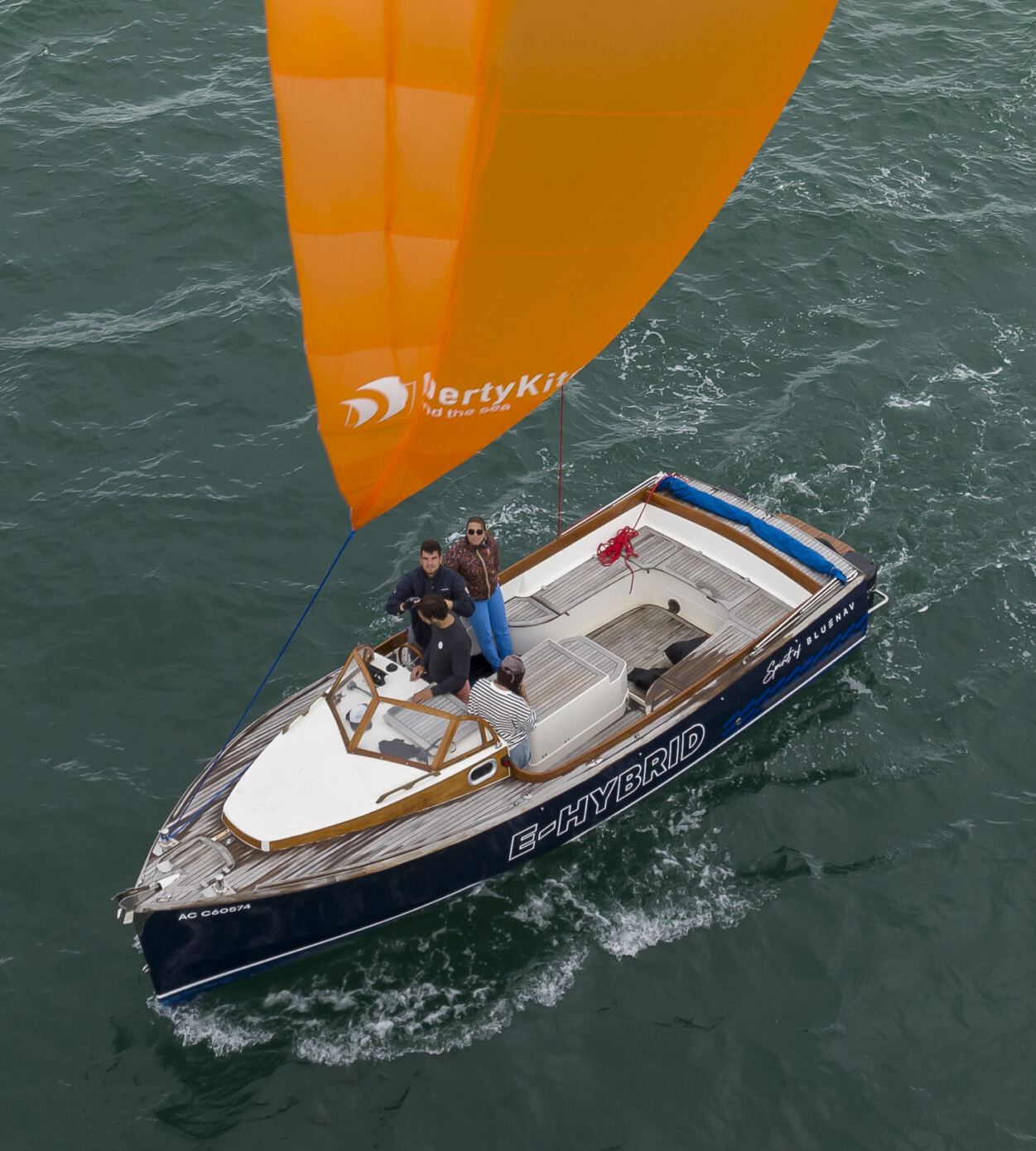 Wind powered LibertyKite® towing a small boat in calm waters - easy to use